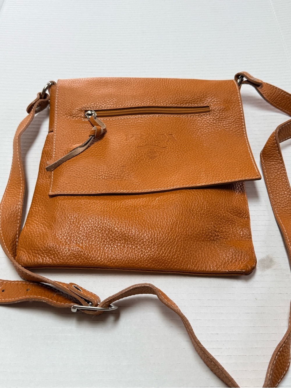 Overland pebbled leather crossbody bag features an adjustable strap
